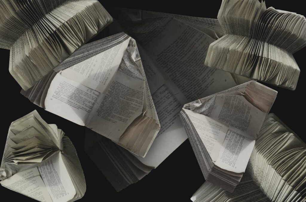 An abstract display of folded vintage books showcasing their pages and textures.