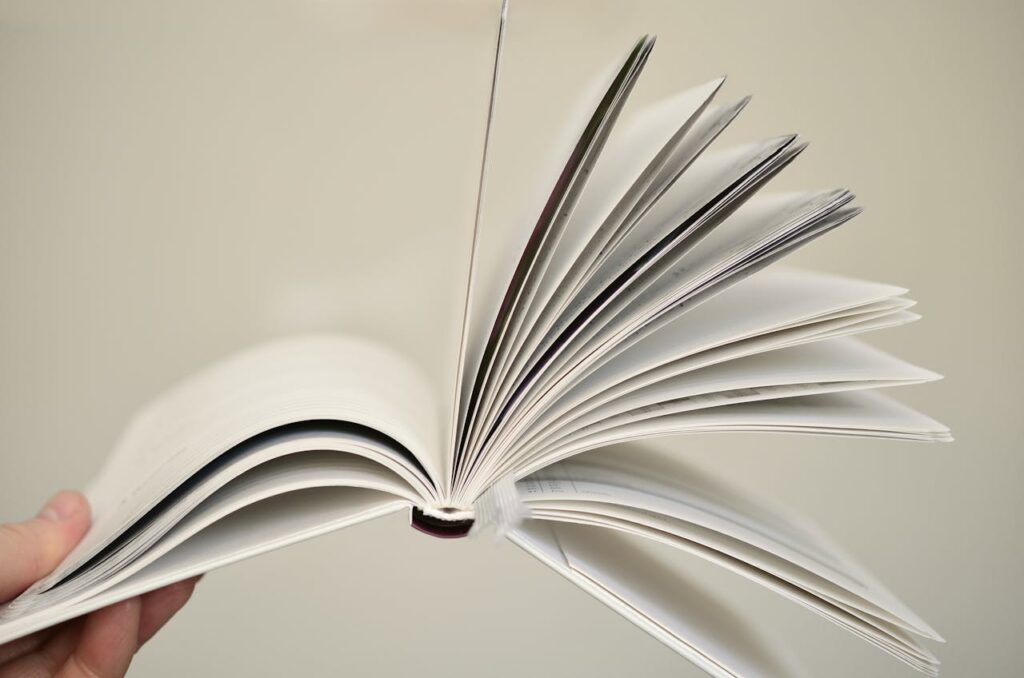 Close-up of an open book with pages flying, symbolizing knowledge and learning.